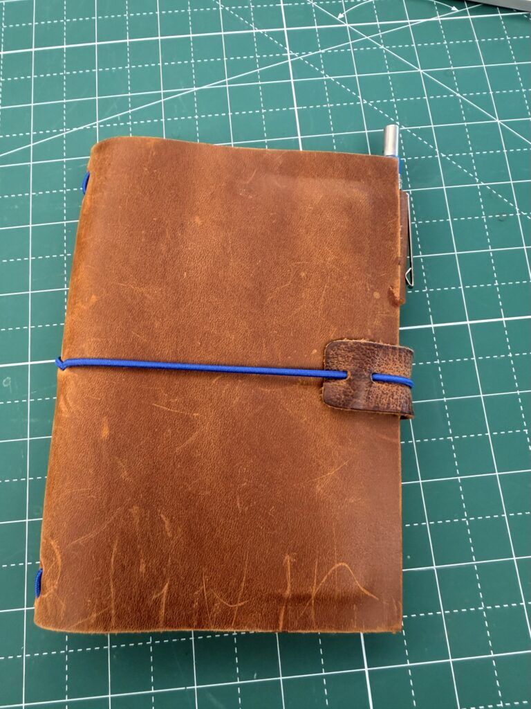 This wallet/notebook is just big enough to hold two Field Notes-sized notebooks. The inner cover has two slots for ID and cards.